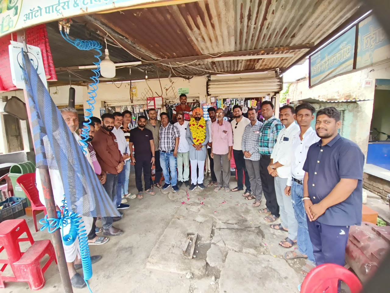 BJP Mahidpur Road Mandal President Guru Charan Chauhan being felicitated with a traditional turban and flower garlands by members of the Anchalik Patrakar Sangh during his birthday celebration in Delchi Buzurg village