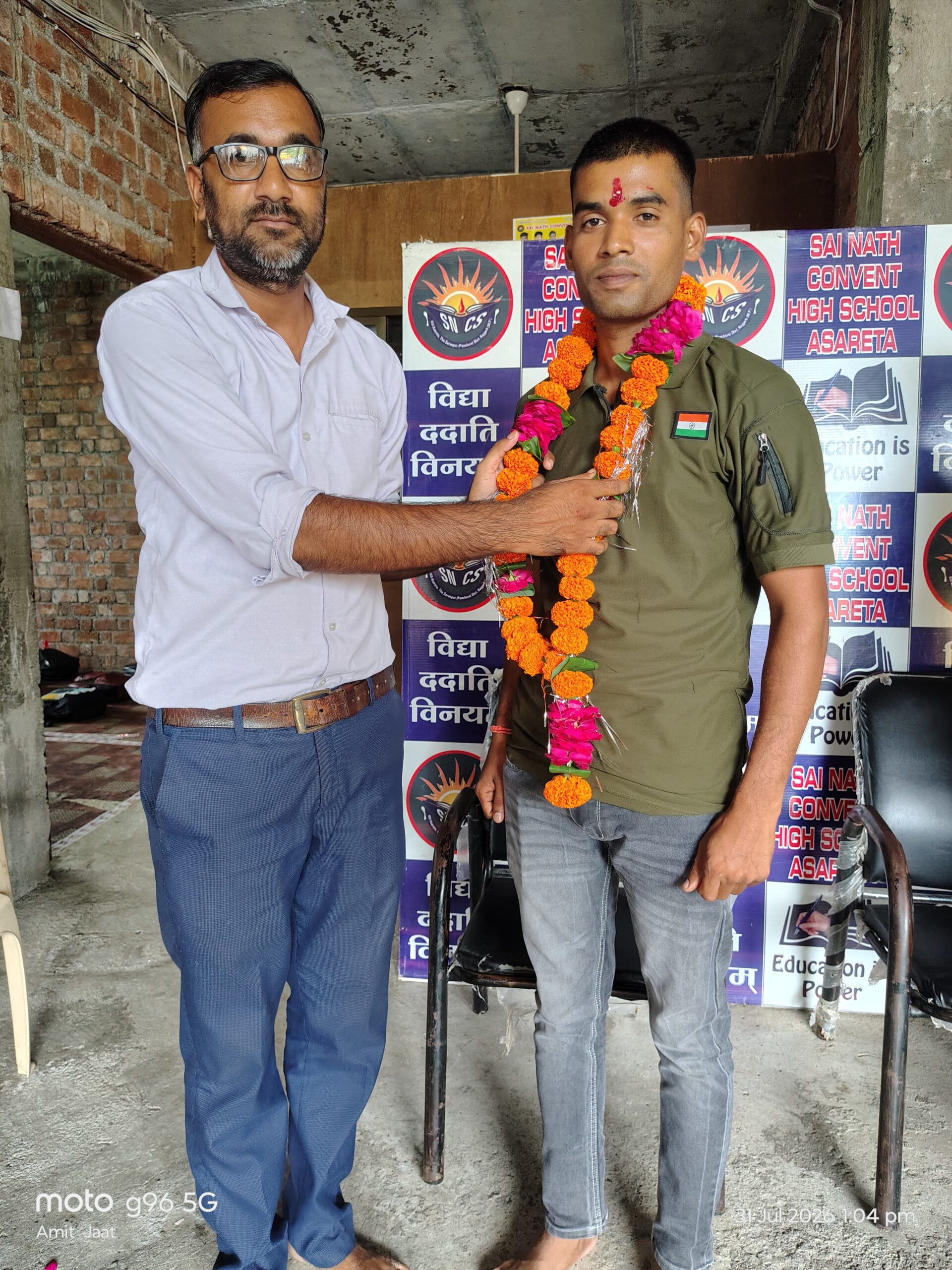 Sai Nath Convent High School felicitates former students Manoh Rajput and Akash Jatav after successfully completing CICF training, with teachers and students participating in the welcome ceremony