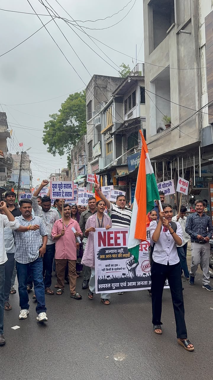 Students, Congress workers and youth stage a protest rally in Alirajpur against alleged NEET exam irregularities and the reported police action on protesting students, before submitting a memorandum to the SDM addressed to the President